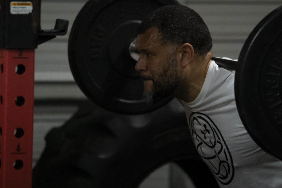 Fame Strength adult member focused during a barbell squat